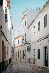 Fototapeta premium Whitewashed alley with shutters in Ciutadella, Menorca