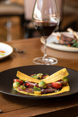 Upscale plated food on table with wine