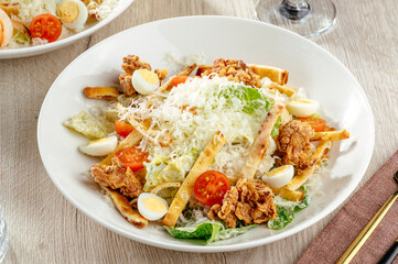 salad with crispy chicken, herbs and parmesan cheese