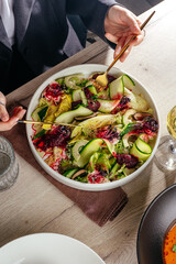girl eating salad in restaurant. zucchini salad