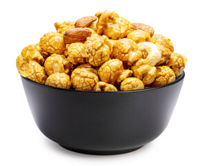 Caramel-coated popcorn with nuts, almonds, and cashew nuts in black bowl  Isolate on white background with clipping path.