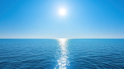Obraz premium Calm blue ocean with sun reflection