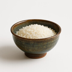 Bowl Filled With Uncooked White Rice on a Simple Backdrop, Highlighting Grains' Texture and Color in Natural Light