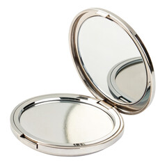 A silver compact mirror reflecting light on a black background.