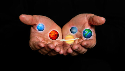 Hands gently hold tiny glowing planets in the dark, capturing a sense of magic, universe-in-your-palm wonder, and cosmic energy in vivid detail.
