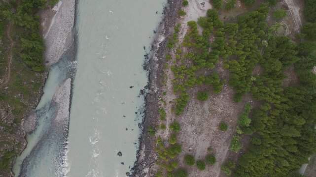 4K Aerial top down shot of Chenab river flowing in Himalaya mountains at Lahaul, Himachal Pradesh, India. Nature, environment concept. Mountain river during summer season.