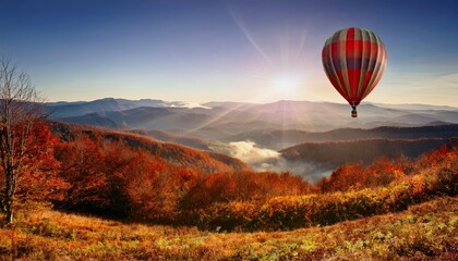Fototapeta premium Hot Air Balloon Soaring Over Autumnal Mountain Landscape at Sunrise