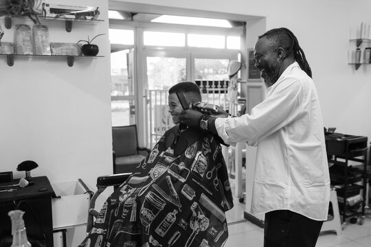 Mixed race young boy having his hair shaved