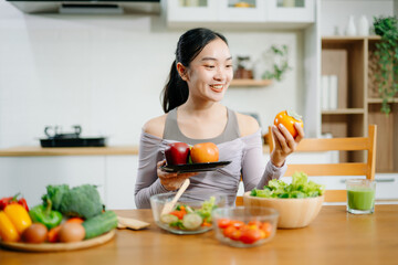 Young woman as she prepares healthy recipes with fresh fruits, vegetables, and nutritious ingredients. an Clean eating , healthy lifestyle.