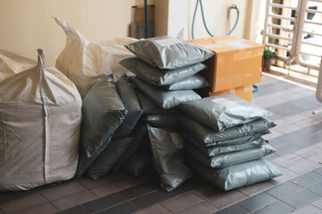 Numerous packages piled up in front of home during an online shopping festival. Delivered at home...