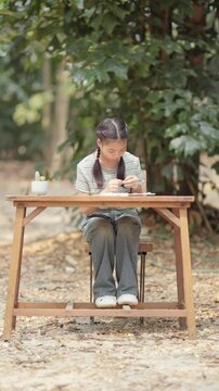 Asian girl making handmade necklace accessories