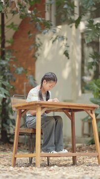 Asian girl making handmade necklace accessories