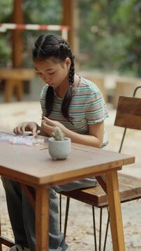 Asian girl making handmade necklace accessories
