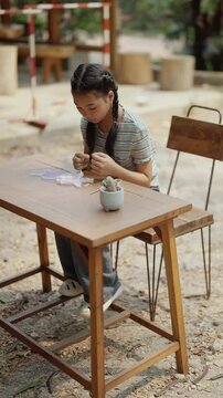 Asian girl making handmade necklace accessories