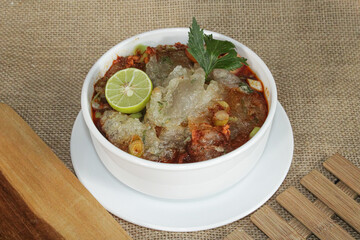 A bowl of spicy restaurant soup dish.