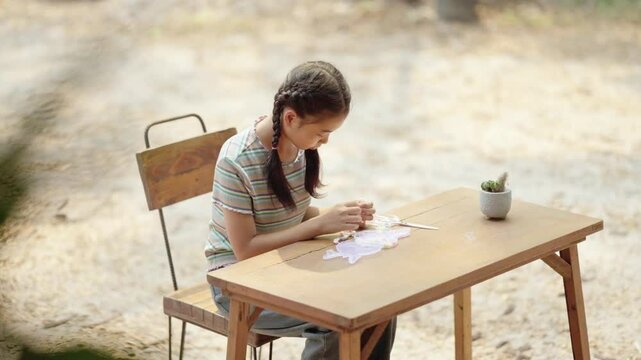 Asian girl making handmade necklace accessories