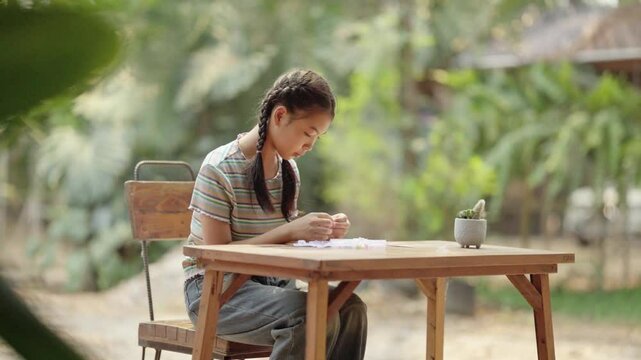 Asian girl making handmade necklace accessories