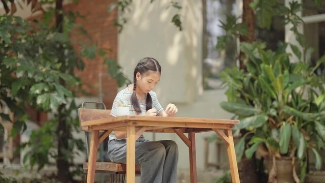 Asian girl making handmade necklace accessories