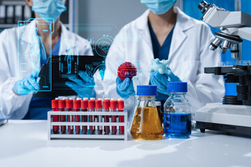 Scientists conducting research in a biotechnology lab, using pipettes and test tubes for medical...