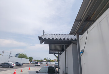 Low angle view, metal sheet roof and gutter of shop food with gutters and sky background