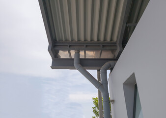 Naklejka premium Low angle view of building or home roof with drain pipes, no people.