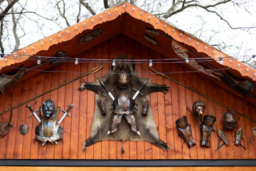  Exterior view of the building with iron helmet, armour medieval knight, sword against wooden roof...