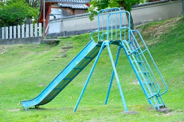 blue slider, empty playground in the park