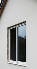 Fototapeta premium Open Window Frame on a White Textured Wall of Residential Building