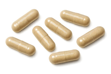 Rows of beige capsules, likely dietary supplements or medications, arranged randomly on a dark background. Concept Beige Capsules, Dietary Supplements, Random Arrangement, Dark Background