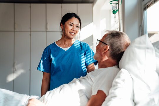 Nurse providing care and support to a patient in a hospital room
