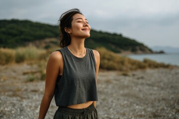 Fototapeta premium Woman Smiling on Beach Enjoying Fresh Air