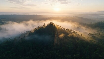 Fototapeta premium Sunrise over misty tropical hills