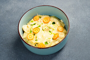 Italian farfalle pasta with cheese and kumquat. In a plate. Close up.