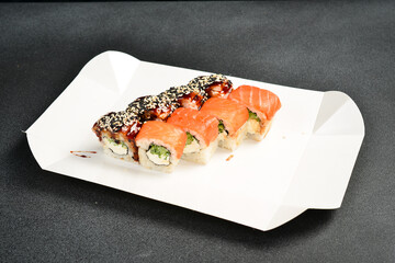 Japanese salmon and eel sushi rolls with Philadelphia cheese. Food delivery. close up