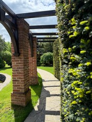 Garden stone path with garden design elements nearby. Fragment of a botanical garden.