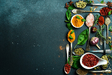 Variety of spices and herbs on kitchen table. Top view. Free space for text.