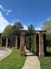 Garden stone path with garden design elements nearby. Fragment of a botanical garden.