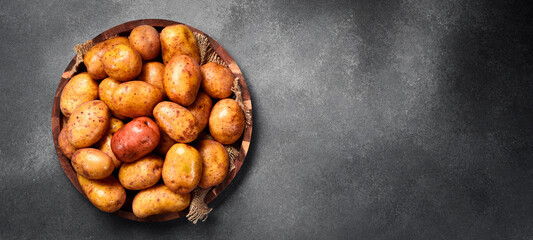 Organic food. Basket with raw potatoes. Top view, close-up.
