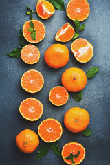 Juicy ripe tangerines on a concrete background. Top view. Citrus fruits.