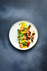 A colorful salad of shrimp, arugula and sun-dried tomatoes. Italian cuisine. Top view.