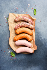 Overhead view of raw sausages and spices. Top view. Free space for text.
