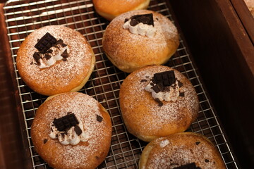 dark chocolate pieces decorate Soft and fluffy Berliner. German Doughnut with swiss chocolate cream inside. High quality photo