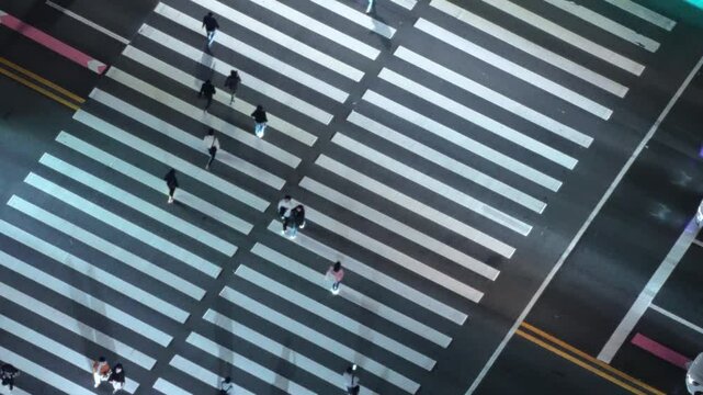 People crossing the road at a zebra crossing on a green light in Yeouido, South Korea.