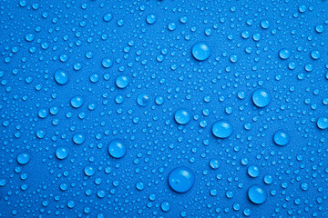 Close up of water droplets on blue background. Macro photo. Top view.