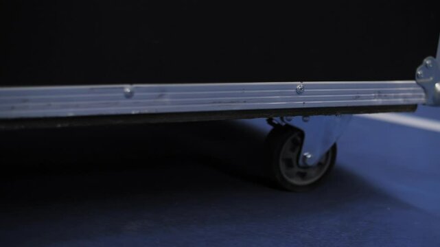 transport Case Wheel on blue floor close-up