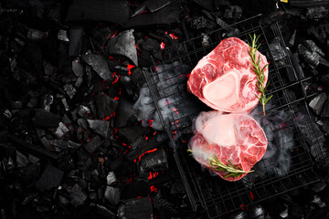 Raw Ossobuco veal steak on a background of hot coals. Top view. Meat Close-up.