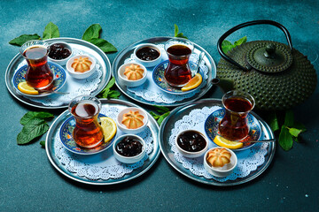 Tea ceremony. Azerbaijani traditional serving of tea. Black tea in a cast iron teapot. Top view.