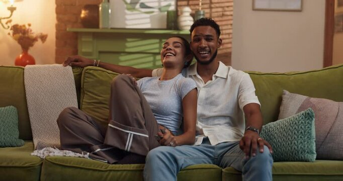 Excited, relax and watching tv with couple on sofa in living room of home for streaming service. Comedy, pointing and television with people in apartment together for entertainment or subscription