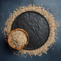 Wooden bowl with peeled sunflower seeds. Close-up. Organic food.