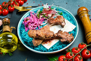 Baked lamb on a plate. Grilled lamb entrecote. Meat dishes.